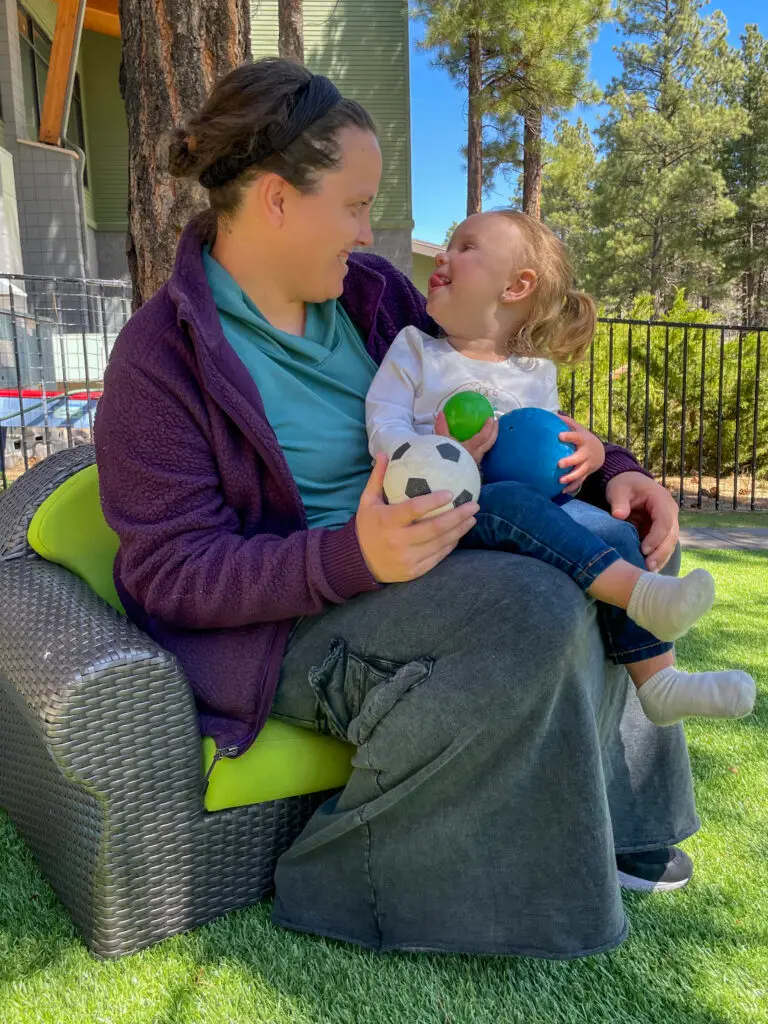 Rachel holding a baby at Evergreen Academy Preschool.