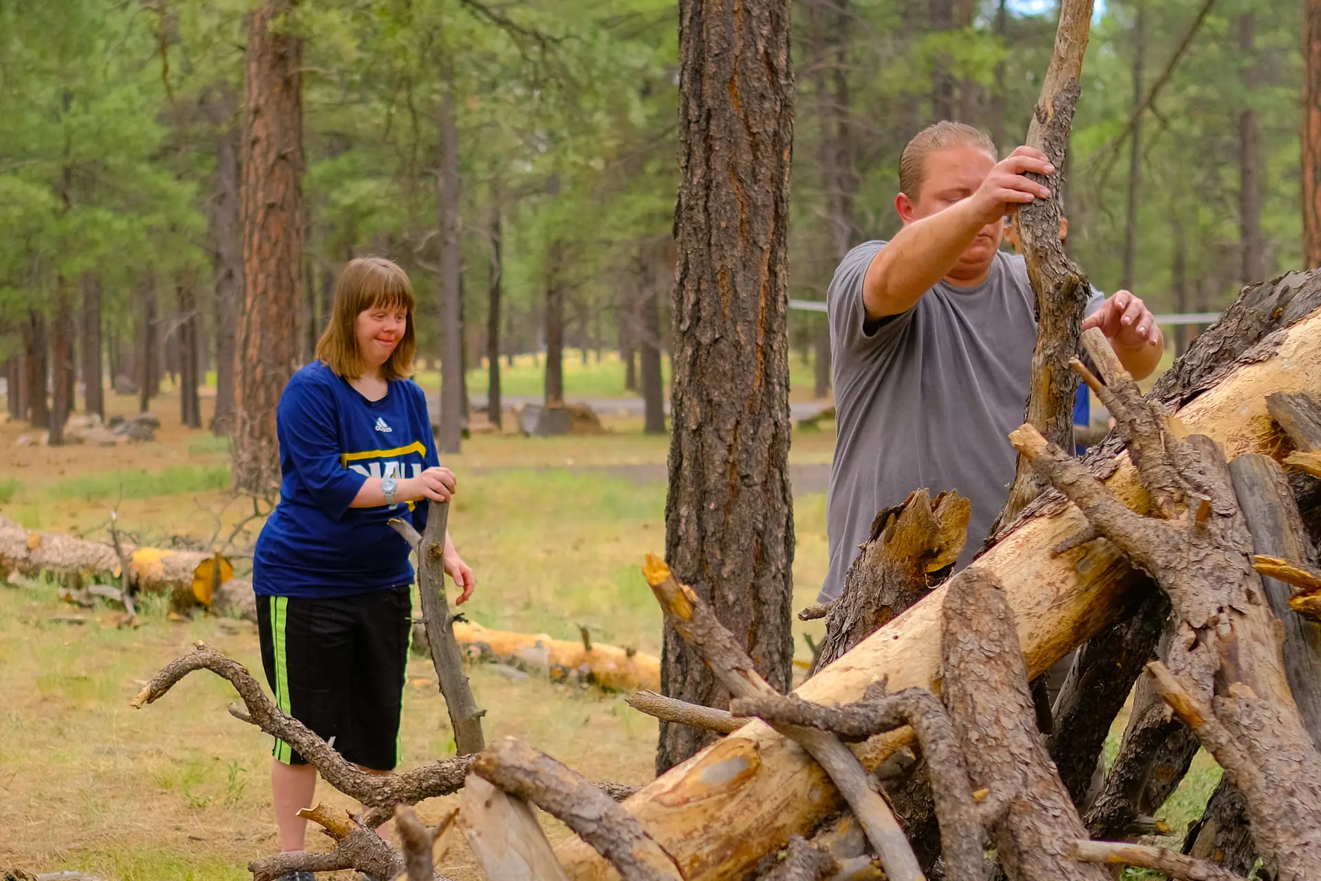 Members of QC's Summer Camp build a lean-to in Fort Tuthill County Park