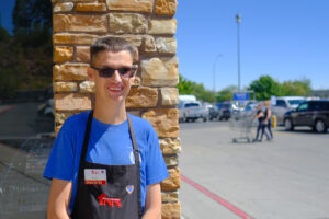 Ryan Day standing in front of Fry's grocery story where he works