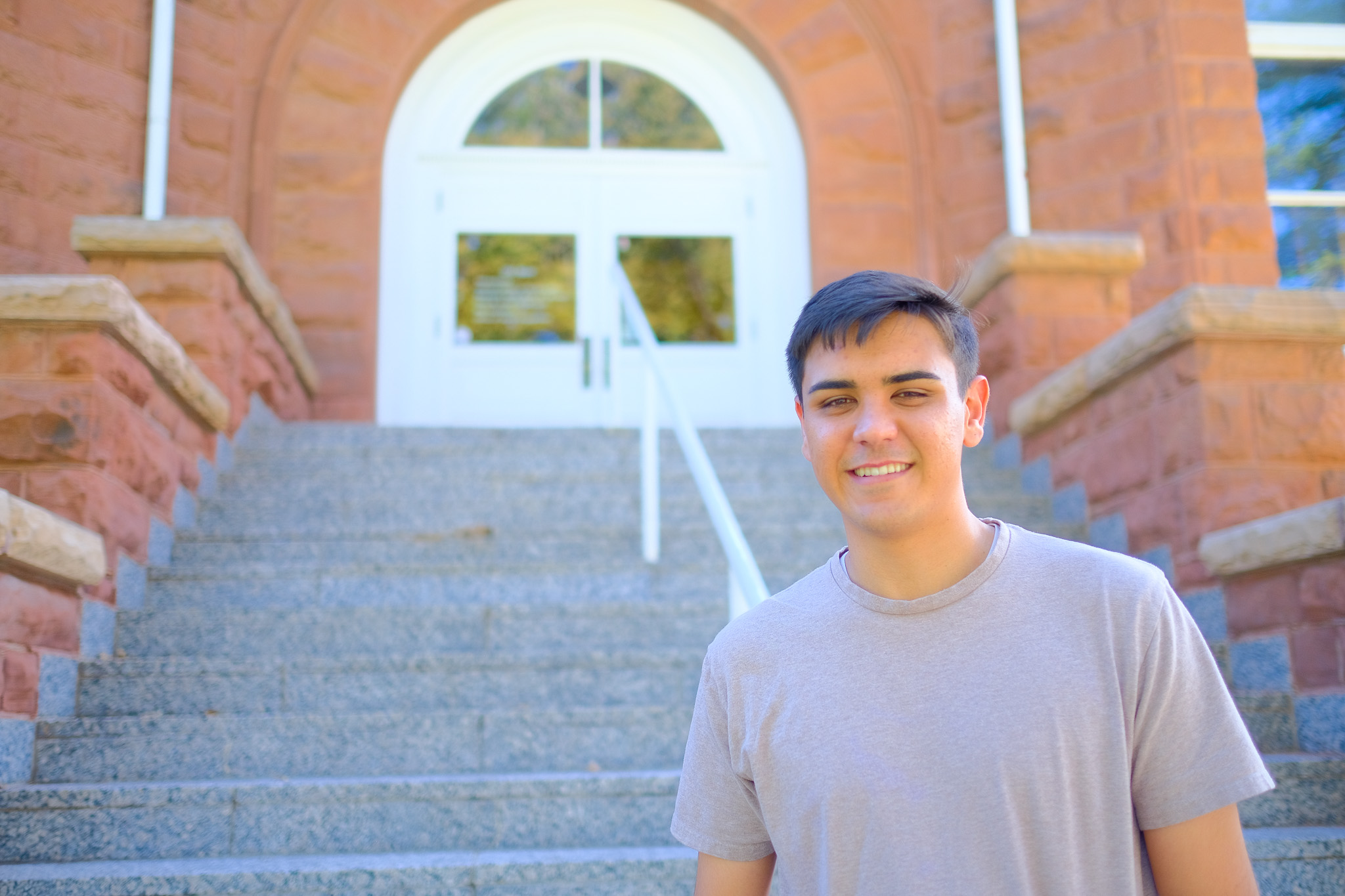 Kyan Bennett standing in front of the Old Main building at NAU