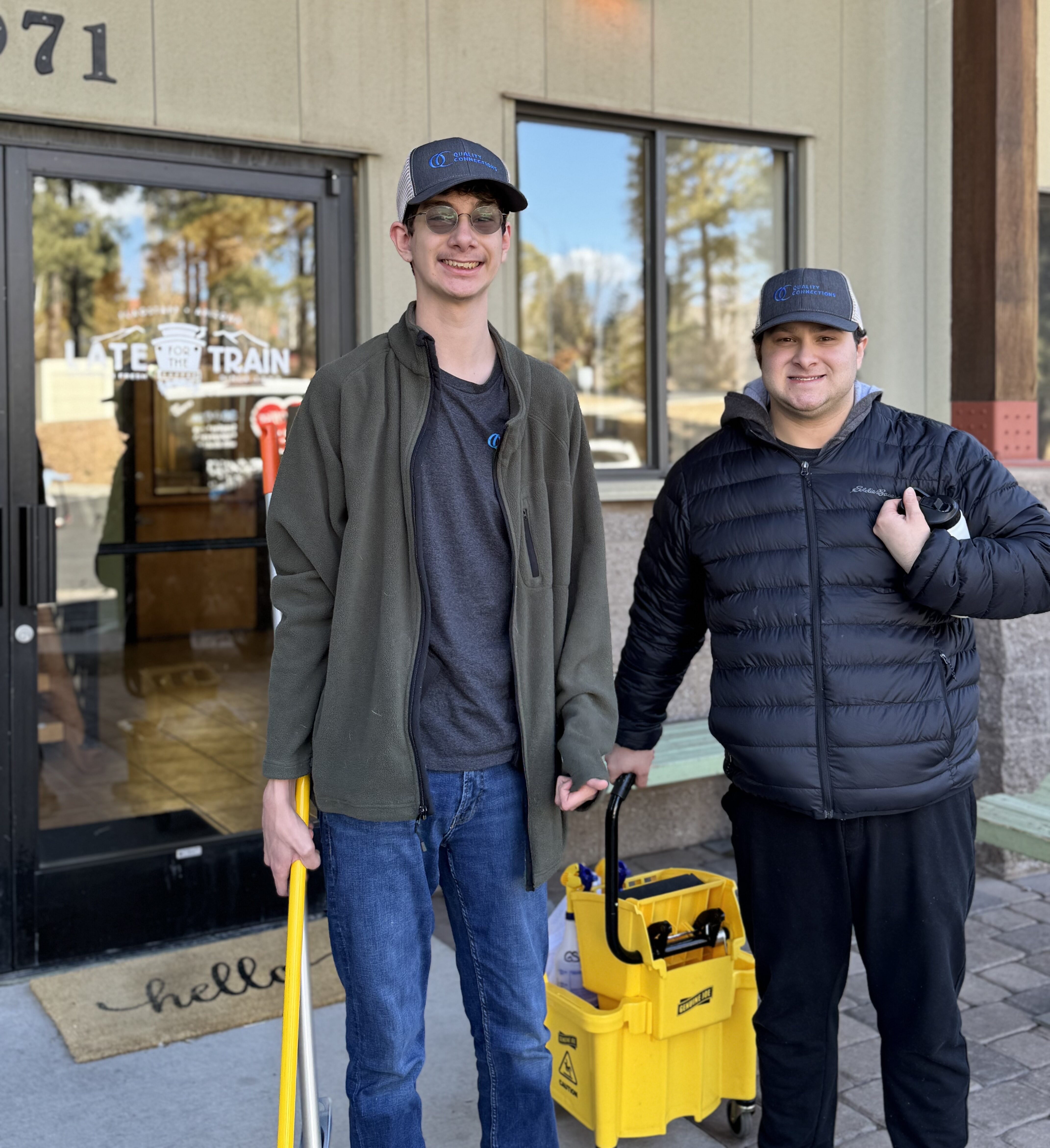 QC Work Training Crew members Jonathan and Ben in front of Late for the Train's Roastery.