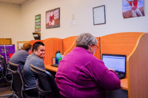 Pathway program participants working on computers.