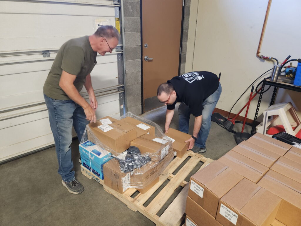 Workers at YEI prepare a pallet of goods.